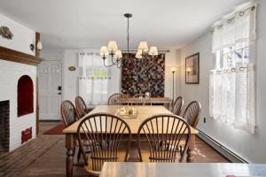 a dining room with a table and chairs at Federal on Exeter Circa 1805 Sleeps 8 in Exeter