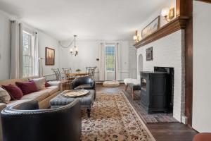 a living room with a couch and a fireplace at Federal on Exeter Circa 1805 Sleeps 8 in Exeter
