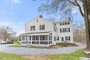 a white house with a tree at Federal on Exeter Circa 1805 Sleeps 8 in Exeter