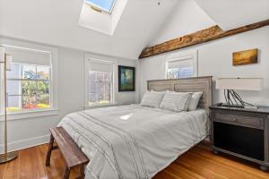 a bedroom with a bed and two windows at Circa 1789 Historic South End Downtown Home in Newburyport