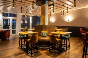 a bar with tables and chairs in a restaurant at Uferdeck - Boutique Hotel in Traben-Trarbach