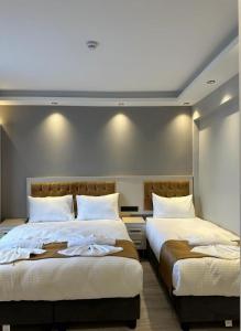 two beds sitting next to each other in a bedroom at Sareban Hotel Istanbul in Istanbul