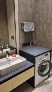 a bathroom with a washing machine and a sink at Sea Breeze Lighthouse 3 in Baku