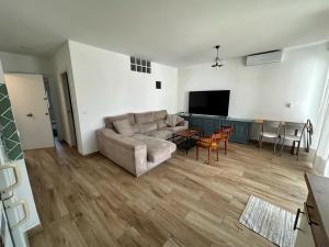 a living room with a couch and a table at ATICO AMPLIO Y LUMINOSO in Seville
