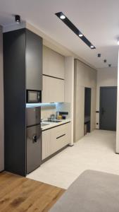 a large room with a kitchen with a stove top oven at Sea Breeze Lighthouse 3 in Baku