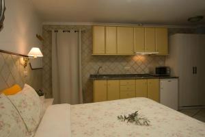a bedroom with a bed and a kitchen with yellow cabinets at Casa Lola in Talarn