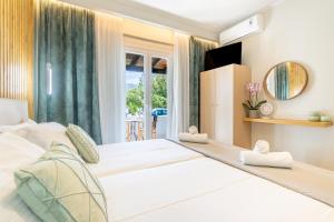 a bedroom with two beds and a window at Villa Maria in Almiros Beach
