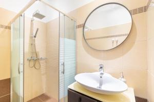 a bathroom with a sink and a mirror at Villa Maria in Almiros Beach