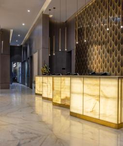 a lobby with a reception desk in a building at Khalidia Palace Hotel Dubai by Mourouj Gloria in Dubai