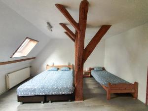 a bedroom with two beds in a attic at De Gelukskever renovated 2024 in Hindeloopen