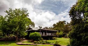 a large house in a yard with trees and grass at Villa 16 @ Rivendell Winery Estate - Yallingup in Yallingup Siding