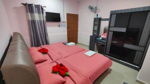 a living room with a red bed and a couch at Santai Desa Chalet musleem 0nly in Brinchang