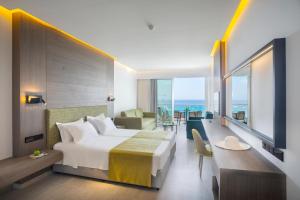 a hotel room with a bed and a view of the ocean at Cavo Maris Beach Hotel in Protaras