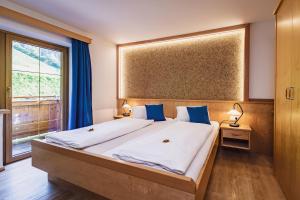 Łóżko lub łóżka w pokoju w obiekcie Panorama Hotel Guggenbichl - inkl Sommerkarte, einmaliger Eintritt ins Tauern Spa & bester Ausblick über Kaprun