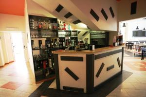 a bar in the middle of a room with alcohol at Albanuova Hotel in Reggio di Calabria