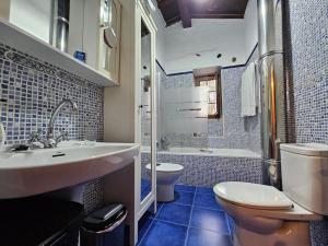 a bathroom with a sink and a toilet and a tub at 14A09 Casa de la Capilla in Colunga