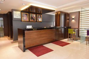 a lobby with a reception desk in a building at Hayat Heraa Hotel in Jeddah