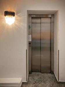 a elevator in a building with a light on the wall at Hotel Neon in Timişoara