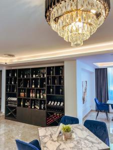 a dining room with a chandelier and a wine cellar at Hotel Neon in Timişoara