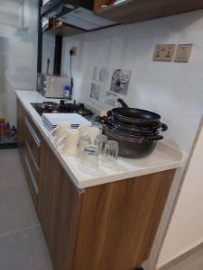 a kitchen counter with a pot and glasses on it at Luxury Apartment Lavington in Mutomo