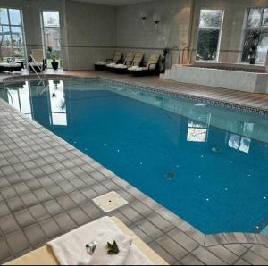 a large swimming pool with blue water in a building at Redcliffe Hotel in Paignton