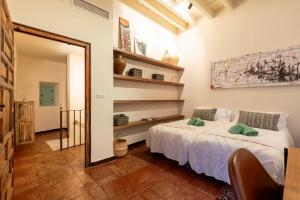 a bedroom with a bed and a mirror at Casa Guadalupe in Seville