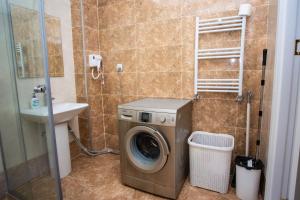 a bathroom with a washing machine and a sink at Private Family apartment in Sumqayyt