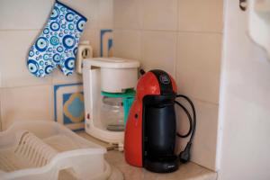 a red and black blender sitting on a counter at Conchiglia Village House in Kiotari