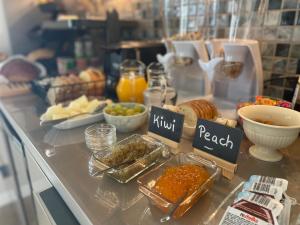 a buffet with bread and other food on a counter at Casa do Mundo Madeira in Gaula