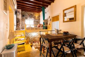 a dining room with a table and chairs at Conchiglia Village House in Kiotari