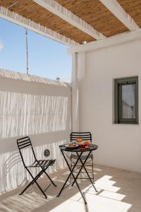 a table and two chairs on a patio at aníko suites White Alley in Mýkonos City