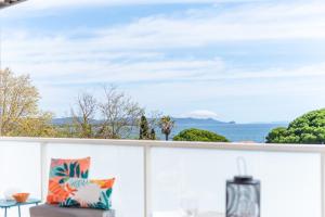 a view of the ocean from the balcony of a house at Appartement Vue Mer 50m plage des Salins Piscine 2 parkings Terrasse in Hyères
