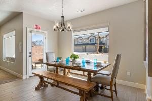a dining room with a table and a bench at Zion's Paradise townhouse in Hurricane