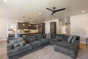 a living room with a large couch and a kitchen at Zion's Paradise townhouse in Hurricane +54 photos