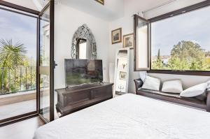 a bedroom with a bed and a large window at Stunning Villa Paola with Swimming Pool & Terrace! in Villasimius