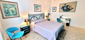 a bedroom with a bed and two blue chairs at Cecilia Rome House in Rome