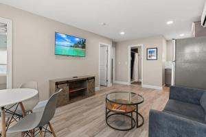 a living room with a couch and a table at Fully Renovated - Walk to Beach - The Americana in Hampton