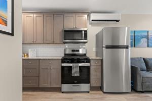 a kitchen with a stove and a refrigerator at Fully Renovated - Walk to Beach - The Americana in Hampton