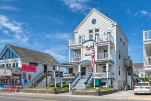 a white building with a flag in front of it at The Porch - Ocean Views - The Americana in Hampton