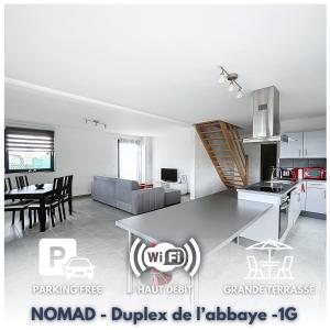a modern kitchen and living room in a house at NOMAD APARTMENTS - Duplex de l'abbaye 