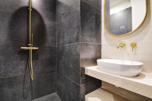 a bathroom with a sink and a mirror at Exceptional studio Place des Vosges Marais in Paris