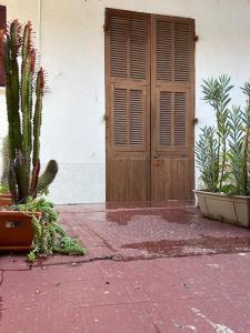 a building with a wooden door and some plants at Monaco chic haven Casino border in Beausoleil