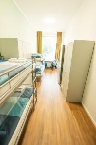 a room with bunk beds in a hospital at NeoHostel in Berlin