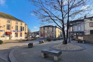 a tree sitting in the middle of a street at Le Nid des Epesses in Les Épesses