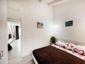 een slaapkamer met een bed in een witte kamer bij Affittimoderni Castelsardo Il Sole - CSSO11 in Castelsardo