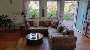 a living room with a couch and a coffee table at Casa Verde Sinnerthal in Neunkirchen