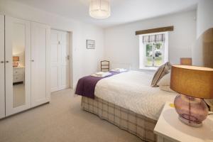 een slaapkamer met een groot bed en een raam bij Brooklands - Lindale near Grange-Over-Sands in Lindale