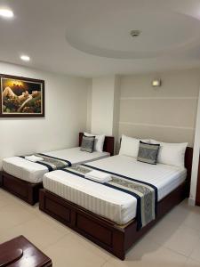 een hotelkamer met 2 bedden in een kamer bij DINH DINH 2 AIRPORT HOTEL in Ho Chi Minh-stad