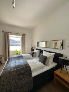 a bedroom with two beds and a large window at Schloß Ort in Passau