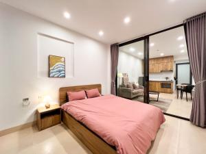 a bedroom with a pink bed and a living room at NINE HOUSING 290 Kim Ma in Hanoi